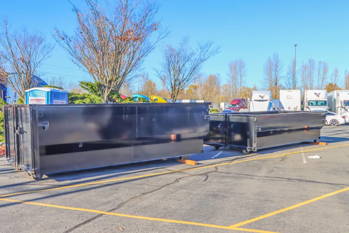 Professional dumpster rental service with roll-off container on residential driveway in Hidden Valley Lake